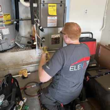 Employee brazing an evaporator coil