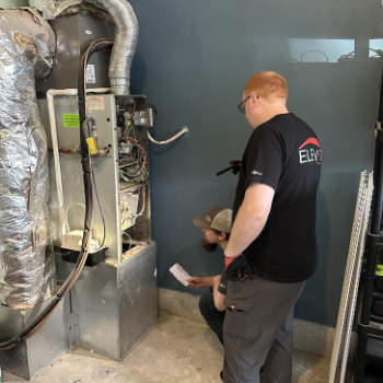 Employees working on a gas furnace